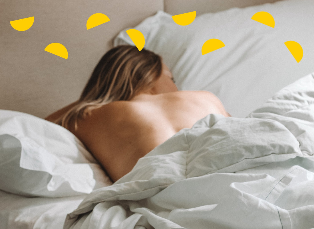 woman sleeping on her front in bed