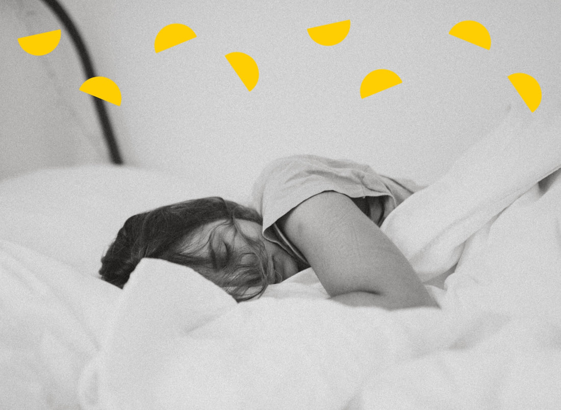 Woman lies sleeping in bed. Illustrated yellow semi-circles form an arching pattern at the top of the image.