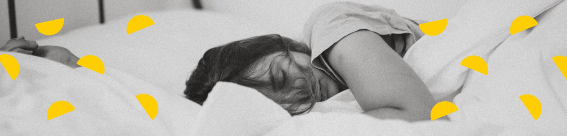 Woman lies sleeping in bed. Illustrated yellow semi-circles form an arching pattern at the top of the image.
