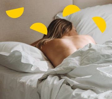 woman sleeping on her front in bed