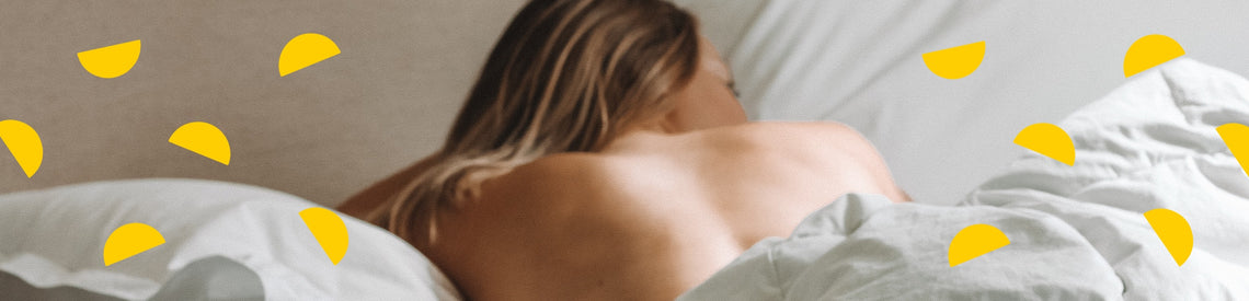 woman sleeping on her front in bed